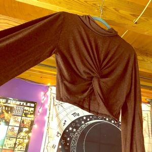 A rust orange/brown crop top with a twisted front